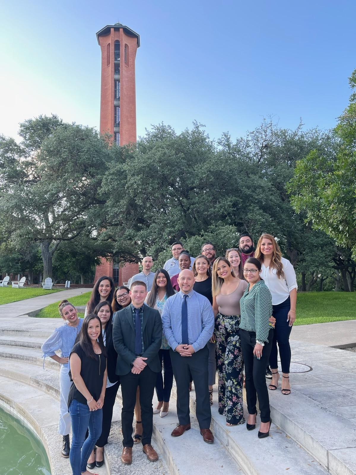 Image of 2022 M Ed. Leadership Students standing next to fountain smiling