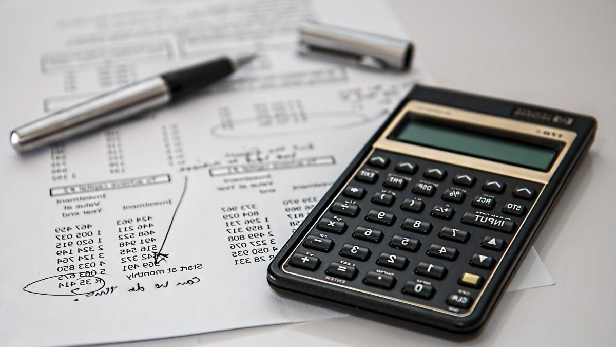 Calculator, financial document and pen