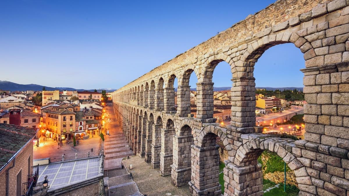 Sunset at the Aqueduct of Segovia, which was built by ancient Romans in Segovia, Spain